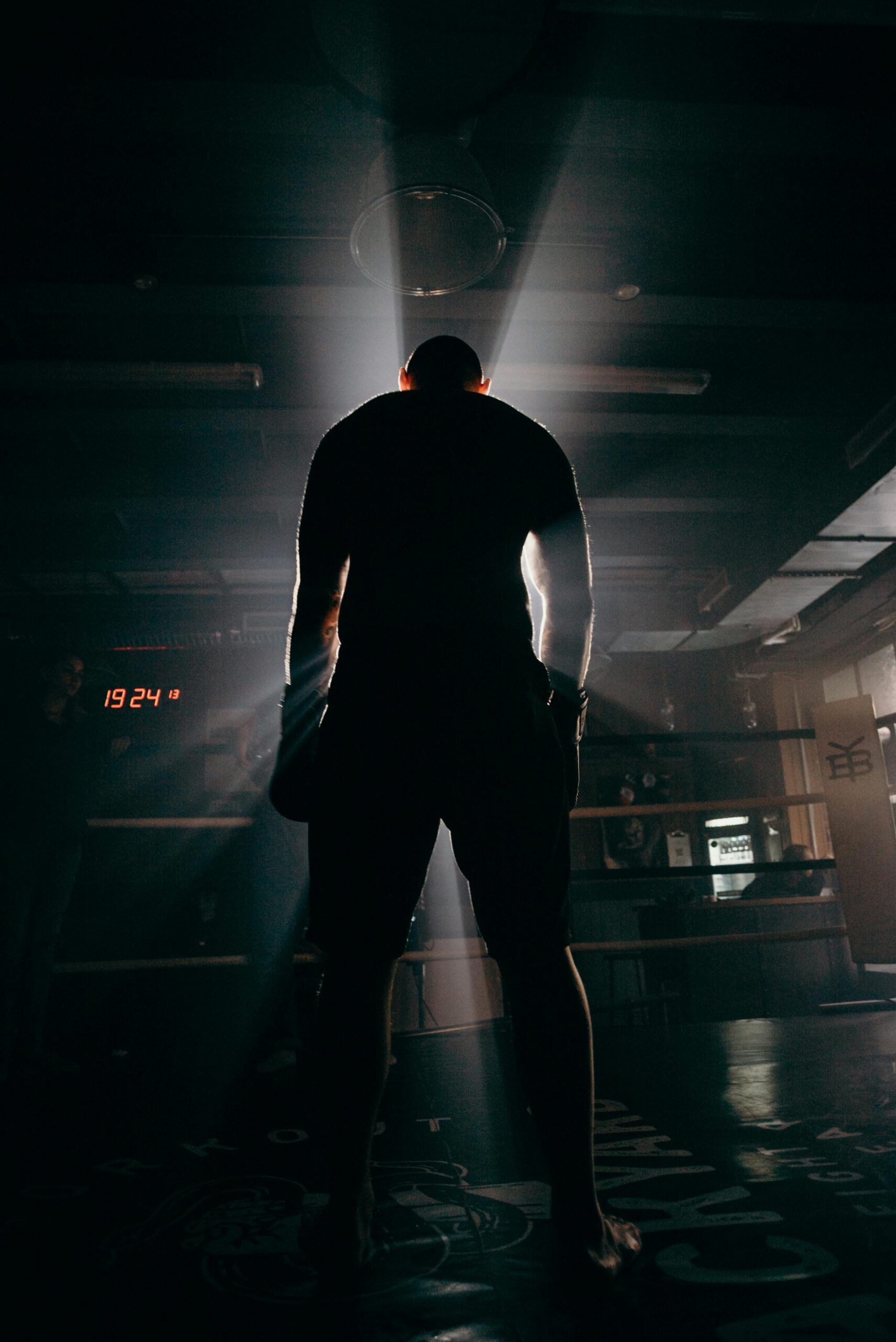 pexels photo 4761779 4761779 Silhouette of a boxer in a gym, illuminated by dramatic beams of sunlight, creating a powerful visual impact.